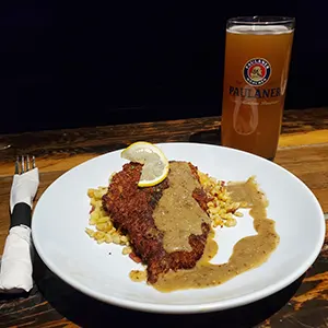 Celebrate Oktoberfest with a Pig & Duke Food Special: $14.95 • Classic Pork Schnitzel with housemade spaetzle fried in butter and bacon with a tangy Guinness mustard sauce. (GST Not Included | House Rules Apply) [Picture: Pig & Duke Plated Pig & Duke Classic Pork Schnitzel and a Paulaner Pint]