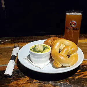 Celebrate Oktoberfest with a Pig & Duke Food Special: $19.95 • Get all Twisted up with our Classic Pretzel & Beer Cheese to boot! (GST Not Included | House Rules Apply) [Picture: Pig & Duke Plated Pig & Duke Classic Pretzel & Beer Cheese and a Paulaner Pint]